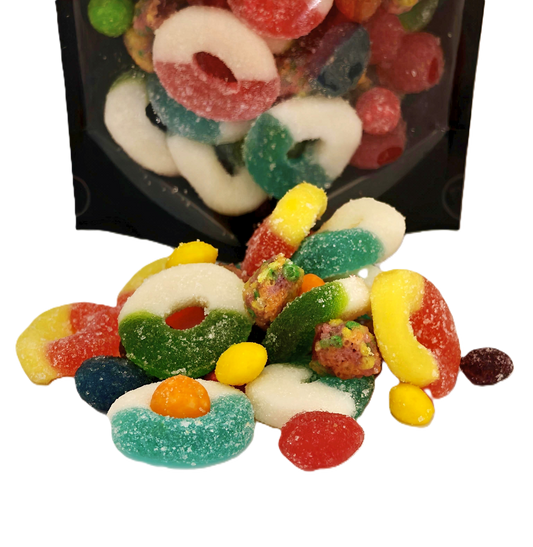 Assorted colorful gummy candies on a white background